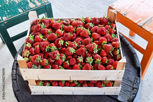 Ripe strawberries in wooden boxes