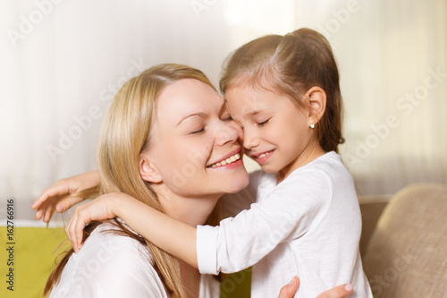  Mum and her cute daughter child girl are playing, smiling and hugging.