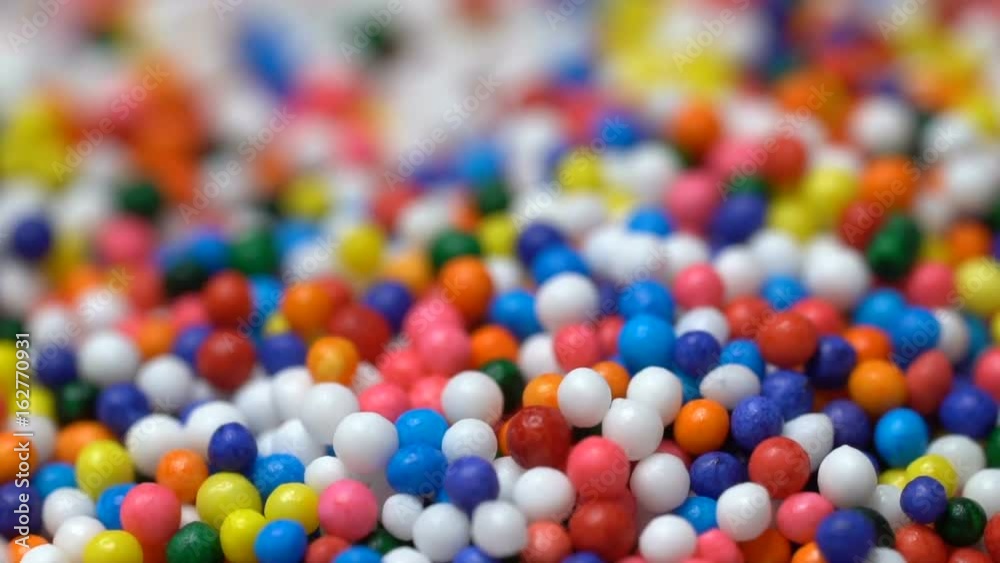 Colorful sprinkles sugar candy pouring down Colorful sprinkles sugar candy pouring down