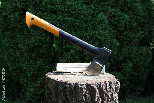 ax stuck in wood block photo