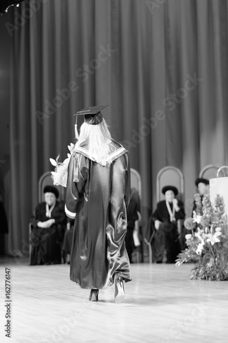 A graduate of the university in a traditional academic mantle at the solemn ceremony of awarding diplomas