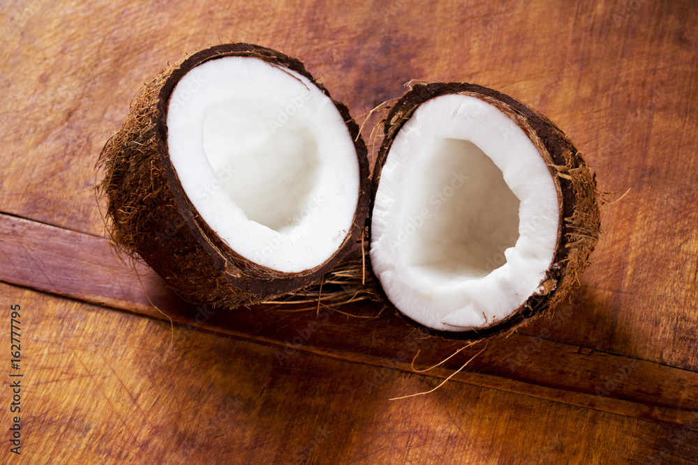 Fresh crushed coconut on a wooden table Fresh crushed coconut on a wooden table