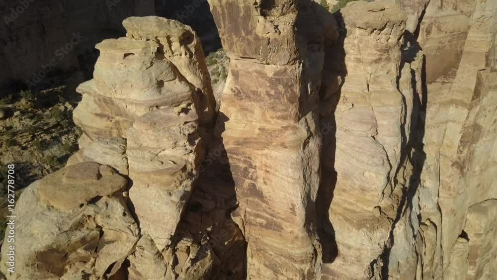 Aerial Eagle Arch San Rafael desert canyon valley Utah pull. Overhead drone view. San Rafael Reef is a geologic feature in central Utah. Eroded into tall fins, domes, cliffs, and deep canyons.