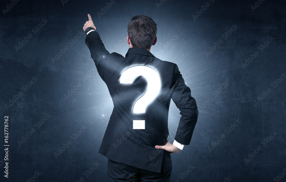 Man standing with question mark on his back Man standing with question mark on his back