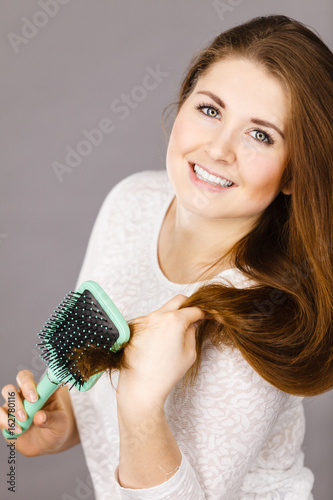 Happy woman brushing her hair