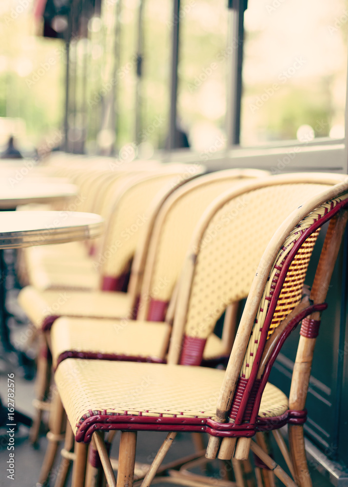 Chairs and tables of an outdoors cafe in Paris