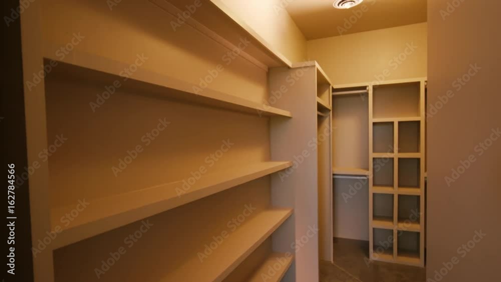Master Closet Sliding Door Open Reveal. large empty walk in closet is revealed by opening sliding barn door
