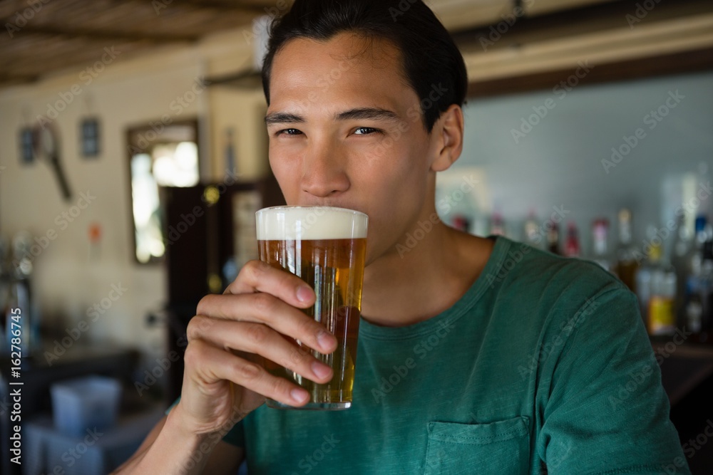 Portrait of man drinking beer