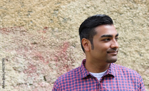 Quadro em tela Close up of young handsome man smiling while looking to the side