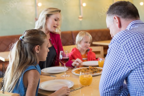 Family talking while enjoying appetizer in restaurant