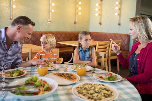 Parents talking to children in restaurant