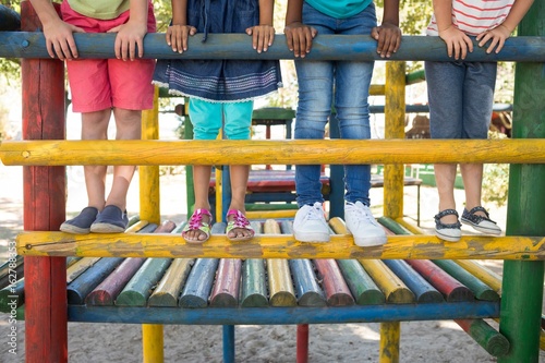 Fotografie Low section of friends standing on jungle gym