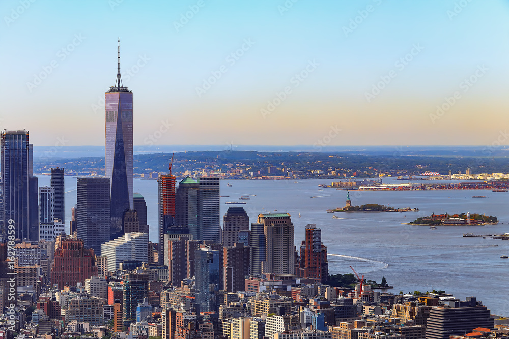Naklejka premium New York City south view at sunrise with morning mist