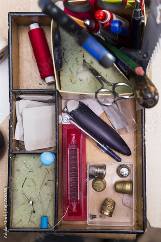 Box with compartments for devices for sewing clothes and creating sketches. photo