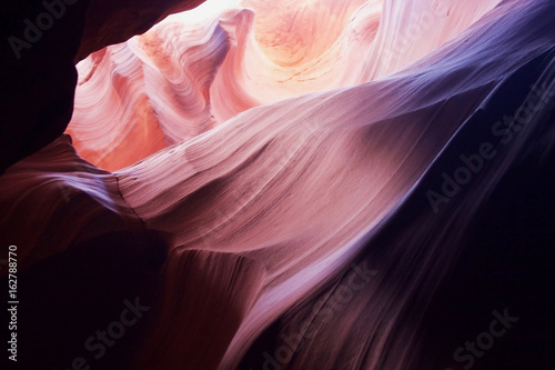 Nature red sandstone textured background. Swirls of old red sandstone wall abstract pattern in Upper Antelope Canyon, Page, Arizona, USA.