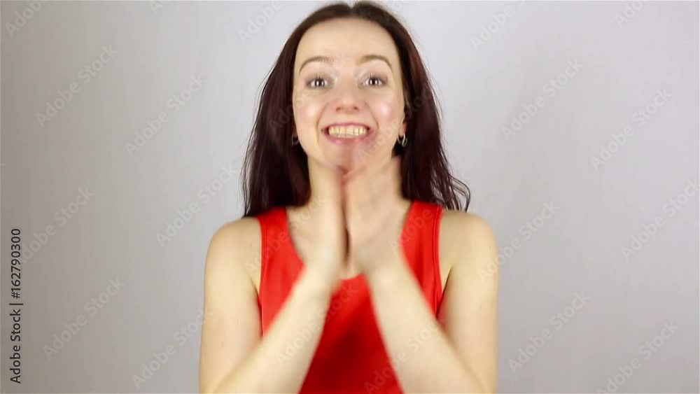 A young beautiful woman applauds with admiration. A young beautiful woman applauds with admiration.