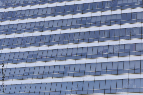 Wall of tall building or glass of skyscraper background.