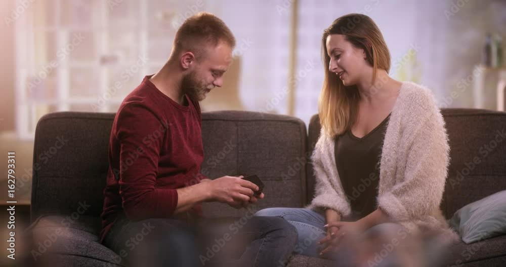 Young couple in love on sofa home making a selfie with tablet Young couple in love on sofa home making a selfie with tablet