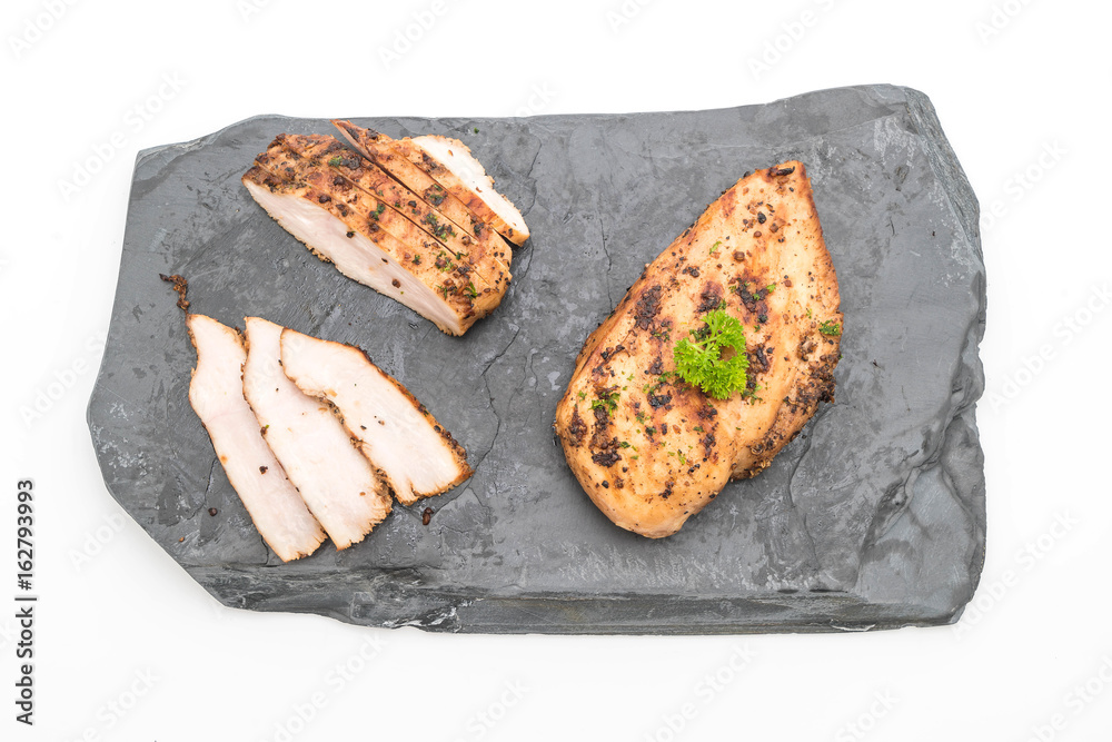 Grilled chicken fillets on slate plate