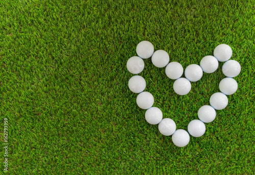 Golf concept : Golf balls arranged as heart symbol.