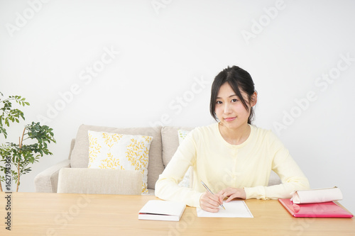 Young woman studying at home © maroke