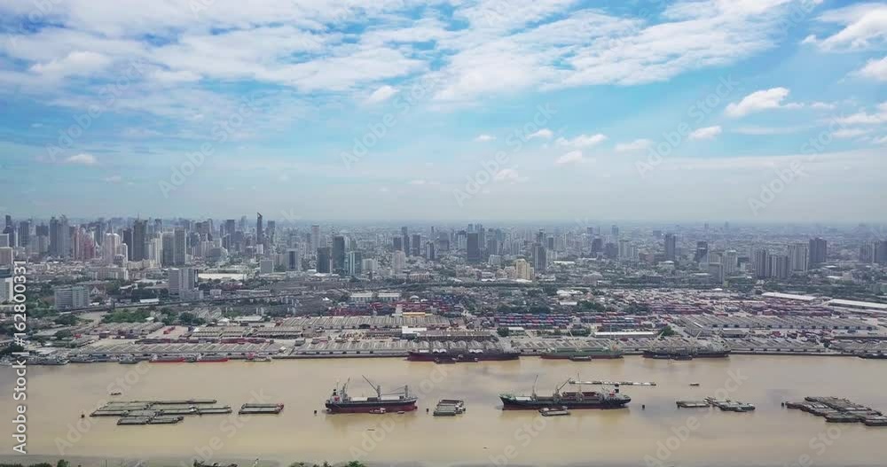 High angle View of Bangkok skyline and view of Chao Phraya River View from green zone in Bang Krachao, Phra Pradaeng, Samut Prakan Province. Harbors and large cargo ships of Bangkok High angle View of Bangkok skyline and view of Chao Phraya River View from green zone in Bang Krachao, Phra Pradaeng, Samut Prakan Province. Harbors and large cargo ships of Bangkok