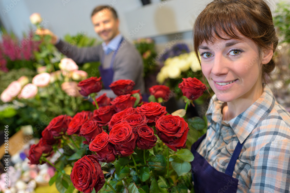Fototapeta premium female and male florist in working in flower shop