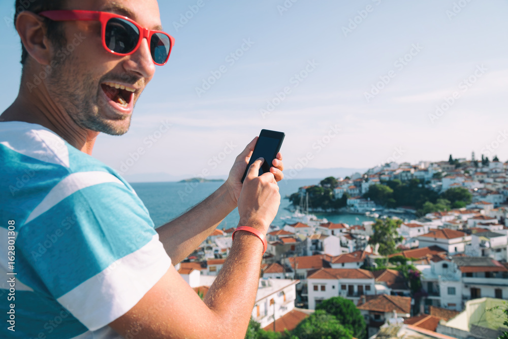 Modern guy using cellphone outdoors.
