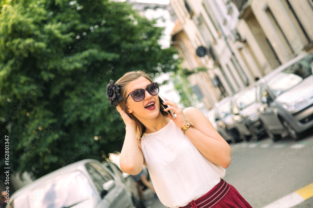Young attractive cute girl talking on her cellphone in the city. Young attractive cute girl talking on her cellphone in the city.