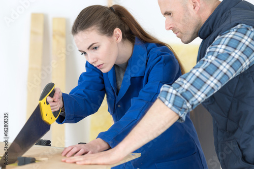 Konstfotografi woman as carpenter during apprenticeship lesson