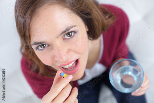 female holding water and pills