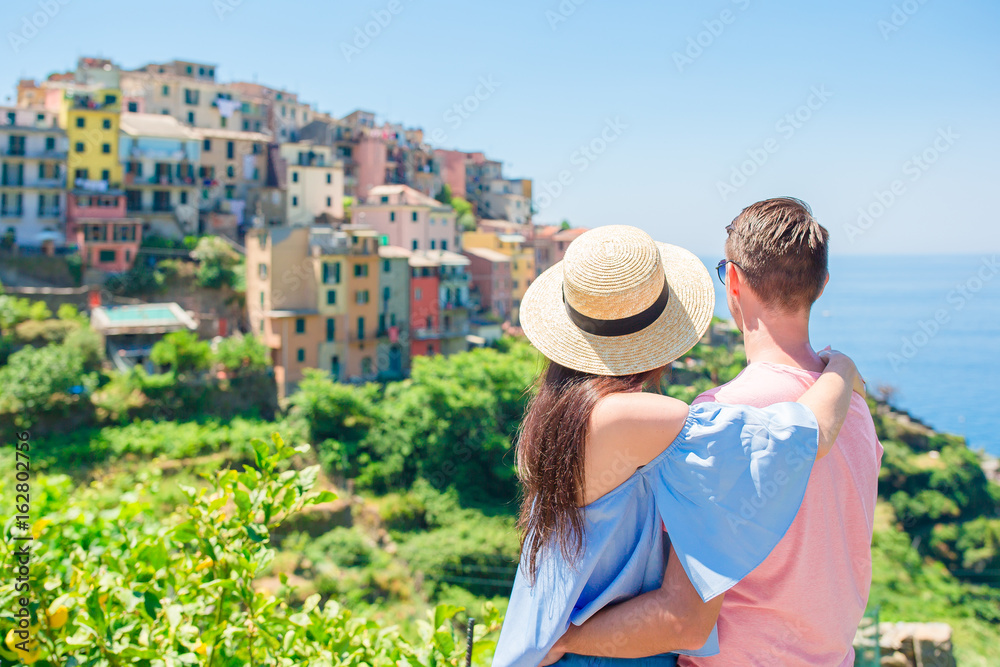 Fototapeta premium Happy family with view of the old coastal town background of Corniglia, Cinque Terre national park, Liguria, Italy ,Europe