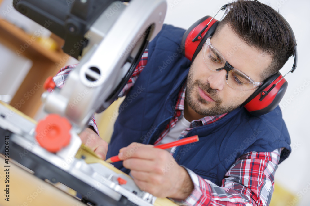Fototapeta premium drawing man before using a circular saw
