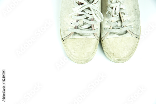Old sneakers dirty on white background.