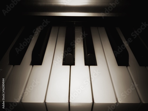 closeup black and white pino key note,in abstract design,vintage tone,blurry light background