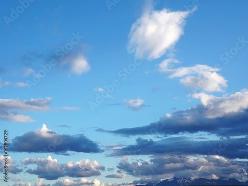 Colored clouds drifting in sunset or sunrise sky, speed up footage
