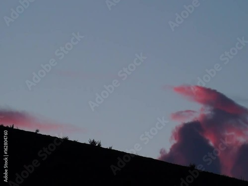 Colored clouds drifting in sunset or sunrise sky, speed up footage