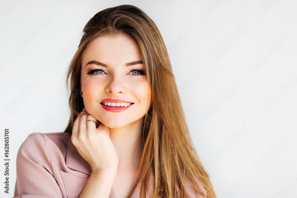 Blond gorgeous girl looking into the camera and smiling on white background Blond gorgeous girl looking into the camera and smiling on white background