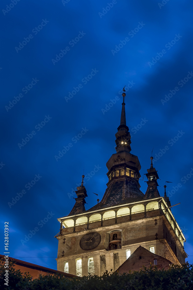 Beautiful vertical view of Turnul cu Ceas, the clock tower of the Citadel, Sighisoara, Romania in the blue light