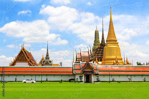 Wat Phra Kaew Temple of the Emerald Buddha or Wat Phrasrirattana Sasadaram Temple for official full name with white clouds blue sky. Wat Ph-ra Kaew is regarded as the most sacred in Thailand photo