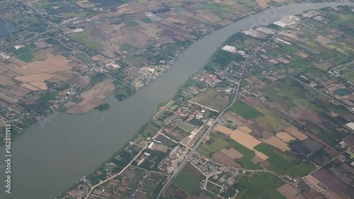 BANGKOK - 25 AUGUST 2015: Top view of Bangkok scene from the air plane on 25 August, 2015. Seen houses in the suburbs and Chao Phraya river.