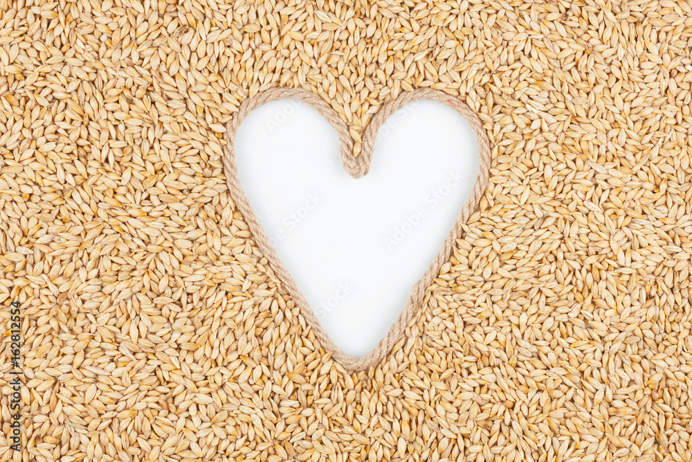 Barley grains and a rope in the shape of a heart with a place for designers. Barley grains and a rope in the shape of a heart with a place for designers.