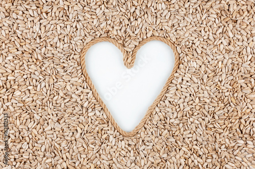 Sunflower seeds and a rope in the shape of a heart with a place for designers.