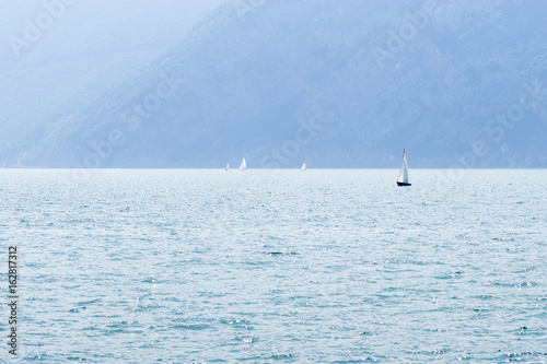 Lake Iseo and sailboats in the small fog, horizontall format photo