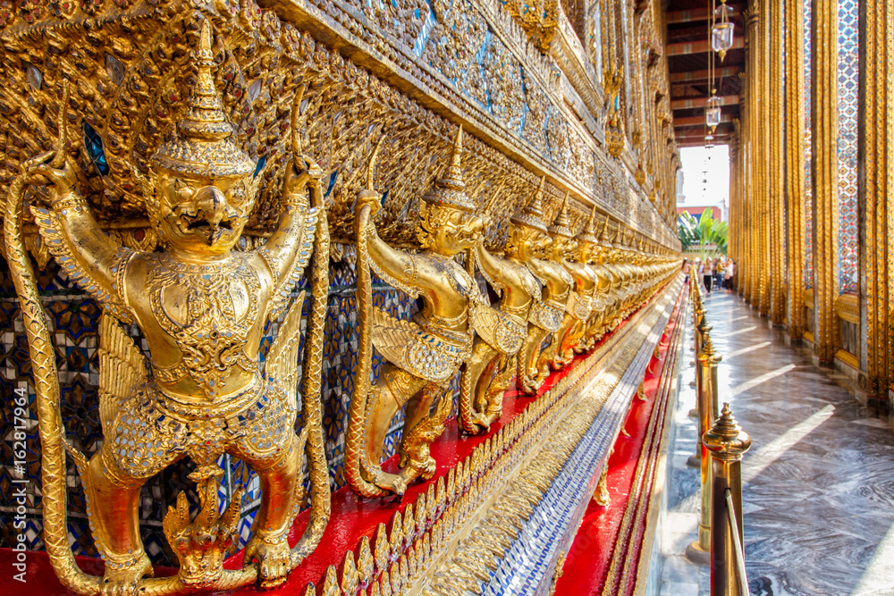 Perspective view of golden religious statue (Statue Garuda) in wat phra kaew temple, Bangkok, Thailand.