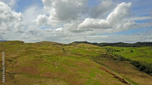 Aerial view of the scottish highlands with single track road and sheep photo