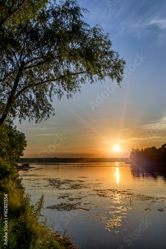 Sunset over the Dnieper river in Kiev, Ukraine, during a warm summer evening. © Maxal Tamor