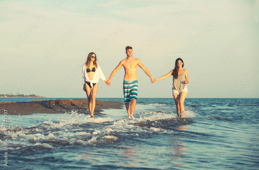 Group of friends together on the beach having fun.