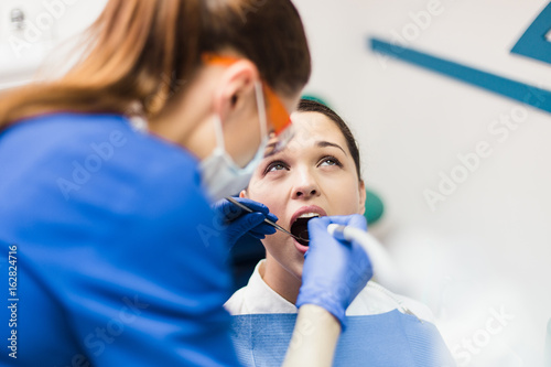 The patient in the dental office make painful procedure