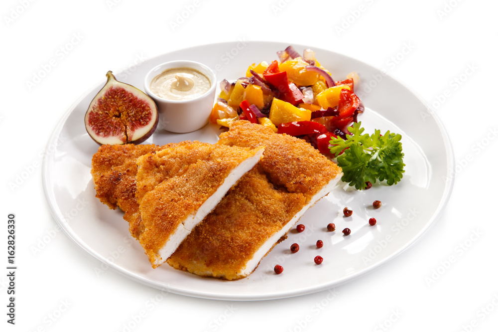 Fried pork chop coat in breadcrumbs and vegetable salad Fried pork chop coat in breadcrumbs and vegetable salad
